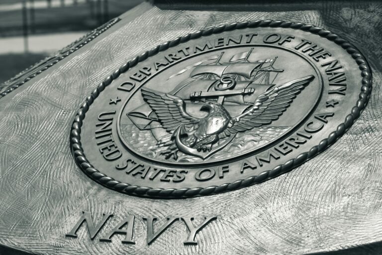 Detailed view of the United States Navy emblem on a monument in Washington D.C., showcasing naval heritage.